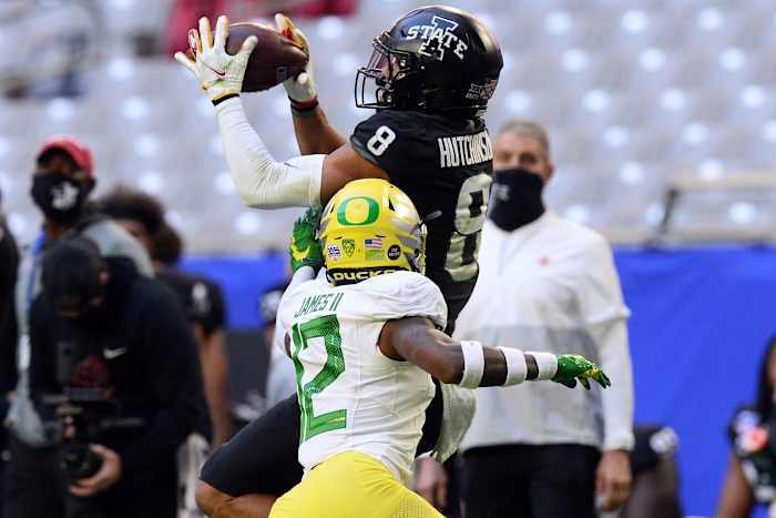 DJ James reaches for the ball against Iowa State wide receiver Xavier Hutchinson in the 2021 Playstation Fiesta Bowl.